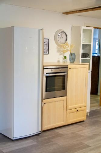 a kitchen with an oven and a clock on the wall at Spacious 220 sqm Apartment with 4 Bedrooms in Tórshavn