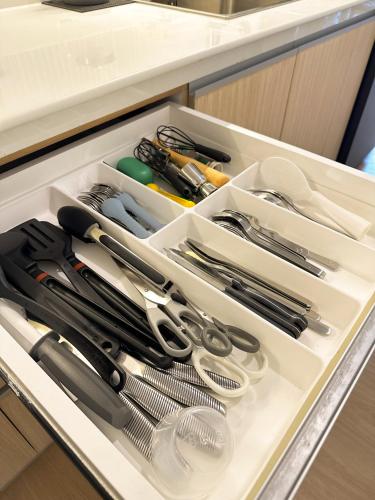 a drawer filled with utensils in a kitchen at Yugen Suites at Pico De Loro in Nasugbu