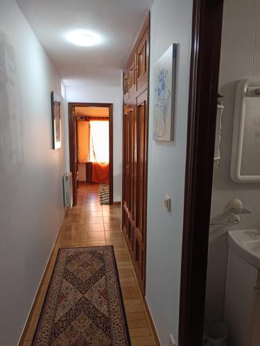 a hallway leading to a bathroom with a sink at B&B Santiago de Redecilla del camino in Redecilla del Camino