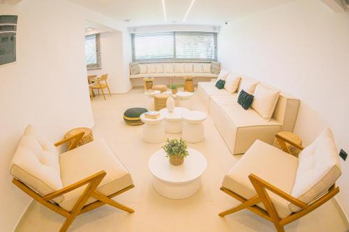 a living room with couches and a table and chairs at Artemis in Makry Gialos