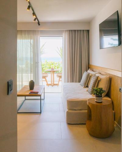 a living room with a couch and a table at Artemis in Makry Gialos