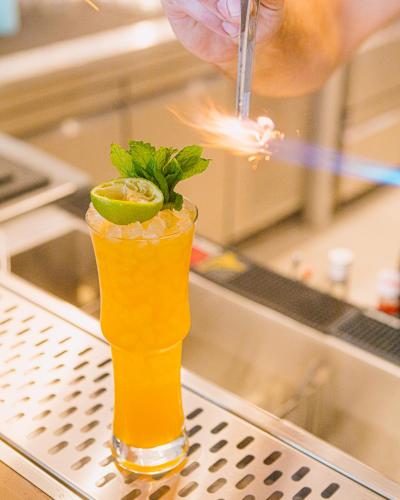 a person is preparing a drink on a bar at Artemis in Makry Gialos