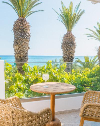 a table and chairs with a view of the ocean at Artemis in Makry Gialos
