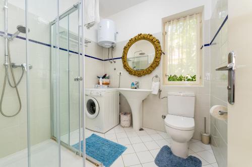 a bathroom with a toilet and a sink and a mirror at MY DALMATIA - Vacation house Maslenica with sea view terrace in Šarić