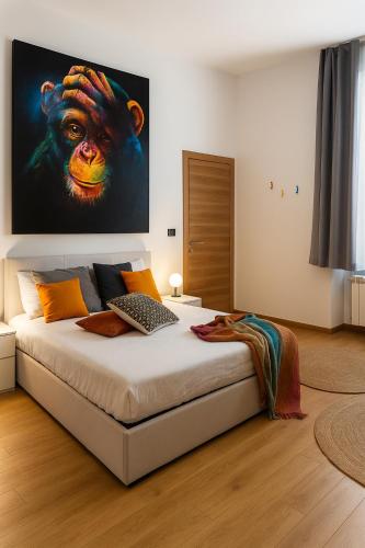 a bedroom with a monkey painting on the wall at Casa vivace in centro Torino by Turin House Collection in Turin