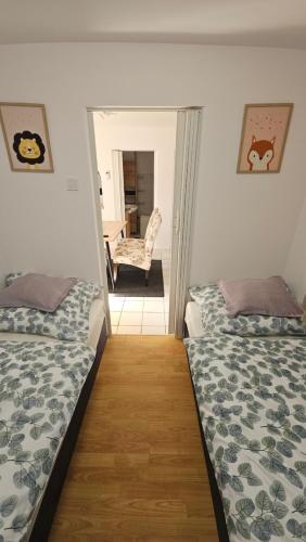 a room with two beds and a chair in it at Ciao Bambino! in Fonyód