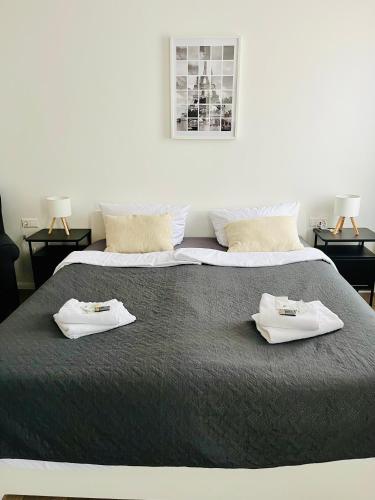 a large bed with two white towels on it at Mythos Hotel Oranienburg in Oranienburg