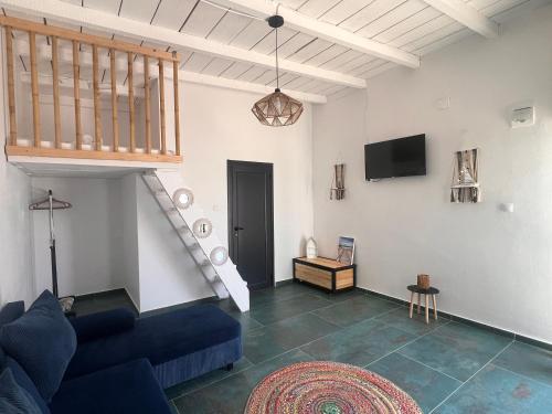 a living room with a blue couch and a staircase at SUN Bungalow Costinești in Schitul
