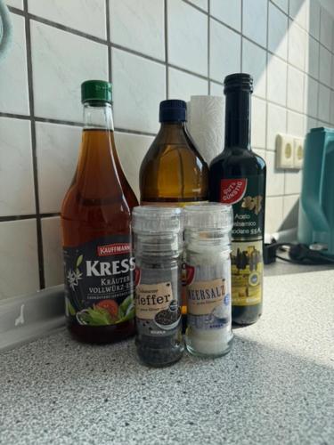 a group of bottles of alcohol and condiments on a counter at HomeBase - Ferien & Monteurzimmer in Geislingen an der Steige