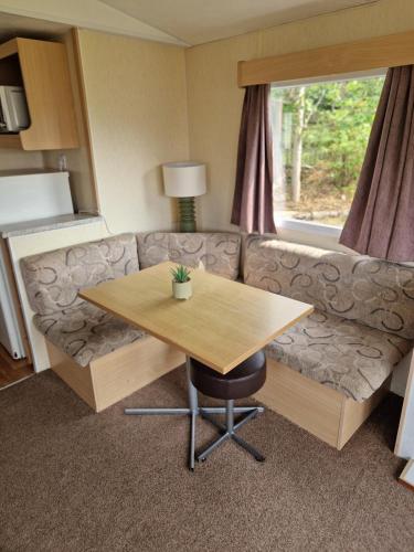 a living room with a couch and a table at The Cosy Coastal Caravan in Morecambe