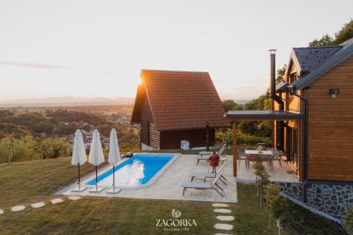 a house with a swimming pool next to a building at Boutique Villa Zagorka in Stubicke Toplice
