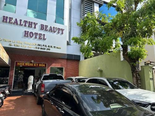 a building with cars parked in front of a hotel at Hotel kỳ hòa in Ho Chi Minh City