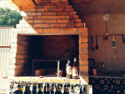 two bottles of alcohol sitting on a brick oven at Hostel Loli in Puerto Iguazú