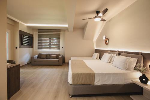 a bedroom with a bed and a couch at Electra Hotel in Stavros