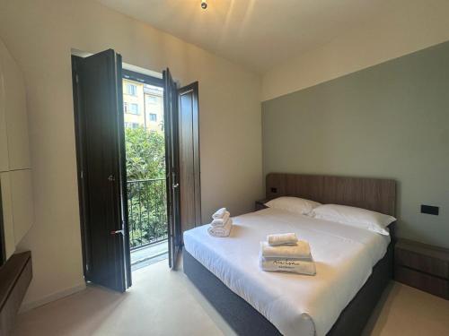 a bedroom with a bed with two towels on it at MIA HOME experience in Milan