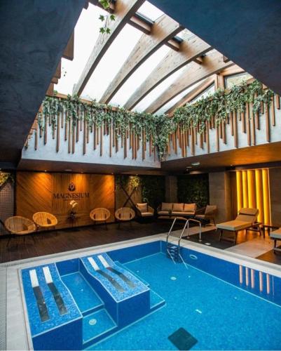 a swimming pool in a building with a ceiling at Lux Apartman Sueno Zlatibor in Zlatibor