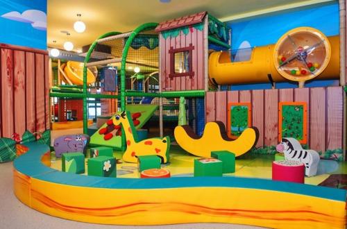 a childrens play area with different types of play equipment at Lux Apartman Sueno Zlatibor in Zlatibor