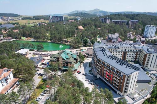 an aerial view of a city with a river and buildings at Lux Apartman Sueno Zlatibor in Zlatibor
