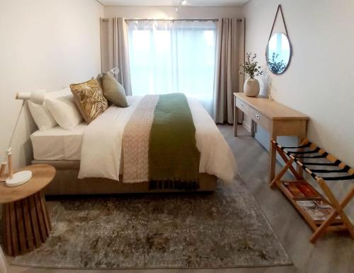 a bedroom with a large bed and a window at Platform 133 2 Tabak in Paarl