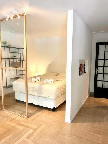 una camera da letto con un letto e uno specchio di Studio Standing 100m de la mer avec balcon Fort Dauphin a Antibes