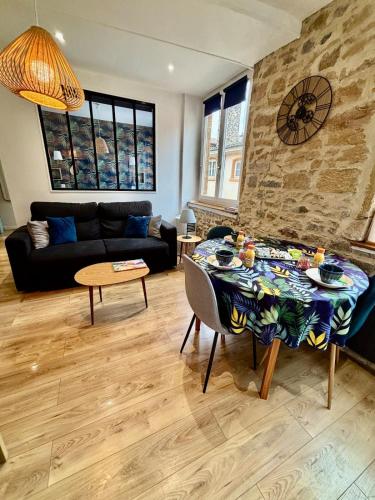 a living room with a couch and a table at petit nid au coeur du Vieux Lyon in Lyon