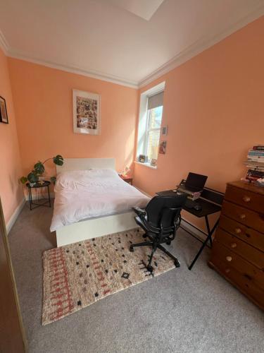 a bedroom with a bed and a desk and a chair at Seven Sisters 1 bed apartment in Moffat
