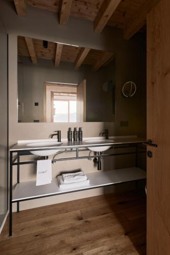 a bathroom with two sinks and a mirror at Colago Private Villas Lake Garda in Toscolano Maderno