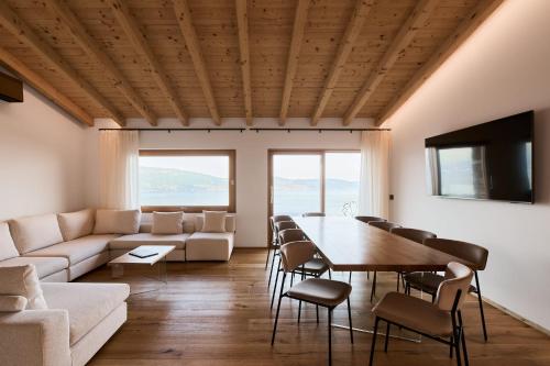 a living room with a table and chairs and a couch at Colago Private Villas Lake Garda in Toscolano Maderno