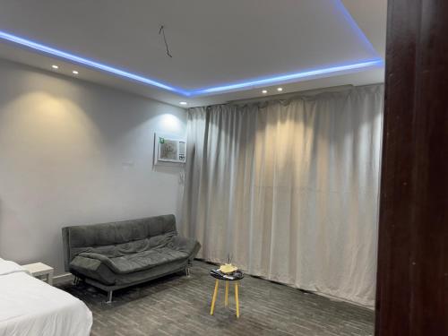 a room with a couch and a bed and a blue ceiling at استديو 1 in Jeddah