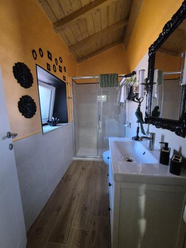 a bathroom with a white sink and a shower at Dream Apartments alloggio turistico in Civitavecchia