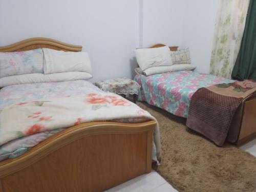 a bedroom with a bed and a couch and a table at Gadou Rooms in Port Said