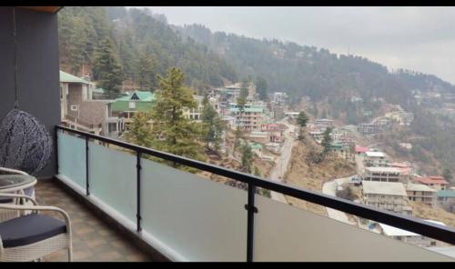 a balcony with a view of a city at Maple vista in Dargai