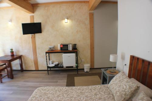 a living room with a couch and a tv at Casa Tacande del Valle in Santiago del Teide