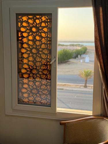 a door with a window with a view of a street at منتجع شاطي الاحلام in Yanbu
