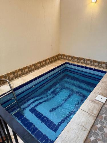 a large swimming pool with blue tile in a room at منتجع شاطي الاحلام in Yanbu