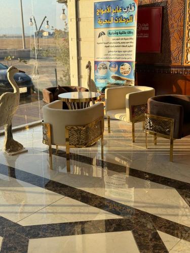 a restaurant with chairs and a table and birds in a store at منتجع شاطي الاحلام in Yanbu