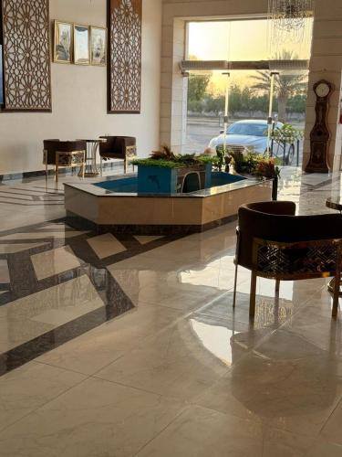 a lobby with a fountain in the middle of a building at منتجع شاطي الاحلام in Yanbu