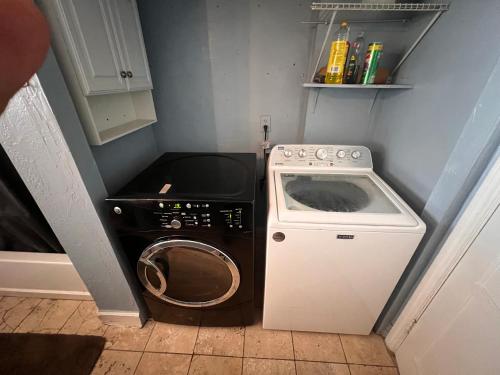 a small kitchen with a washing machine and a stove at Downtown Neighborhood Room 1 in Phoenix