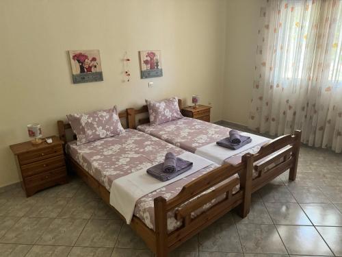 a bedroom with a bed with two hats on it at Alex house Thassos in Skala Sotiros