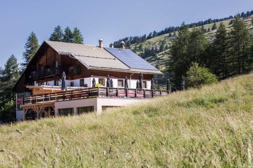 a house on the side of a hill at Hotel Spa L'Equipe in Molines-en-Queyras