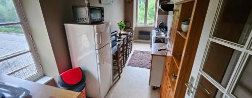 Il comprend une cuisine équipée d'un réfrigérateur blanc et d'un four micro-ondes. dans l'établissement appartement entier, 2 chambres, 7 couchages, tout équipé, à La Forest-Landerneau