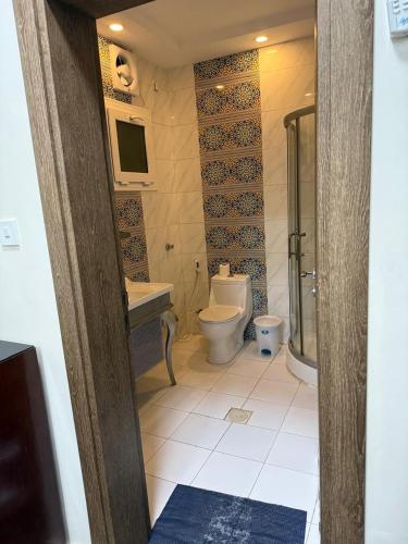 a bathroom with a toilet and a sink at منتجع شاطي الاحلام in Yanbu