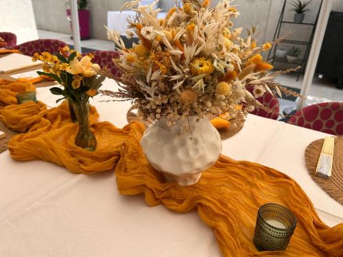 a table with a vase of flowers on a table at Enjoy The Alps in Flachau
