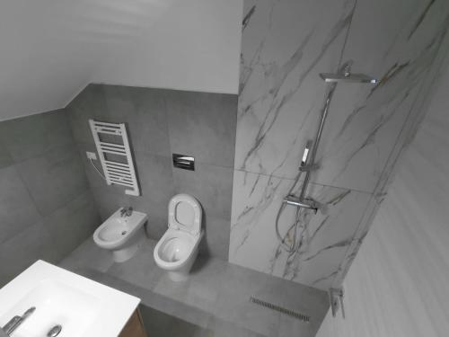 a bathroom with a toilet and a sink and a shower at Max in Condofuri