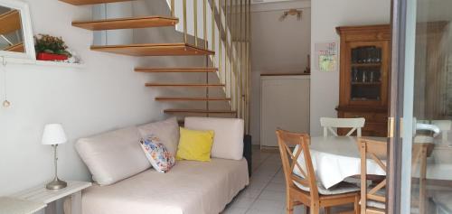 - un salon avec un canapé, une table et un escalier dans l'établissement Le petit FrEd, à Seebach
