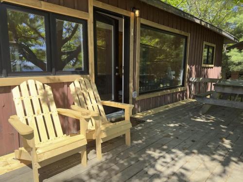 two chairs sitting on the front porch of a house at 3-Bedroom Cottage #1 - Sand Bay in Dillon