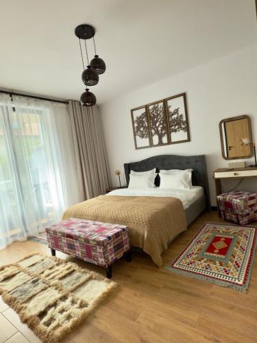 a bedroom with a bed and a large window at Vila Ferdinand Spa and Retreat in Sinaia