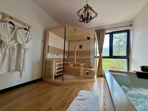 a large glass shower in a room with a window at Vila Ferdinand Spa and Retreat in Sinaia