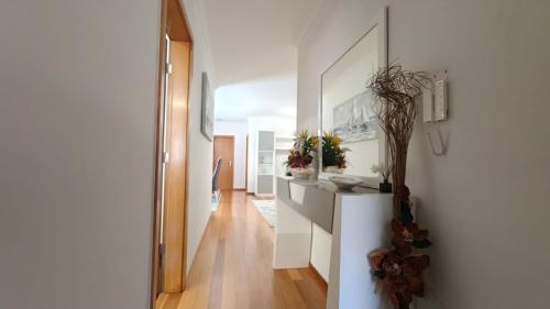 a hallway of a home with white walls and wooden floors at Apartamento Luar in Ribeira Brava