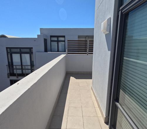 a view of a balcony of a building at Beachfront Penthouse with patio and free parking in Cape Town